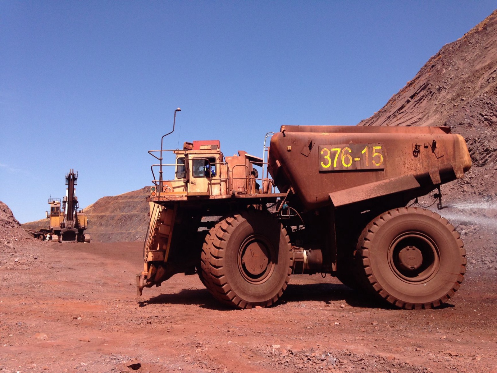 Large mining truck at a quarry in Thabazimbi, South Africa, under clear blue sky.