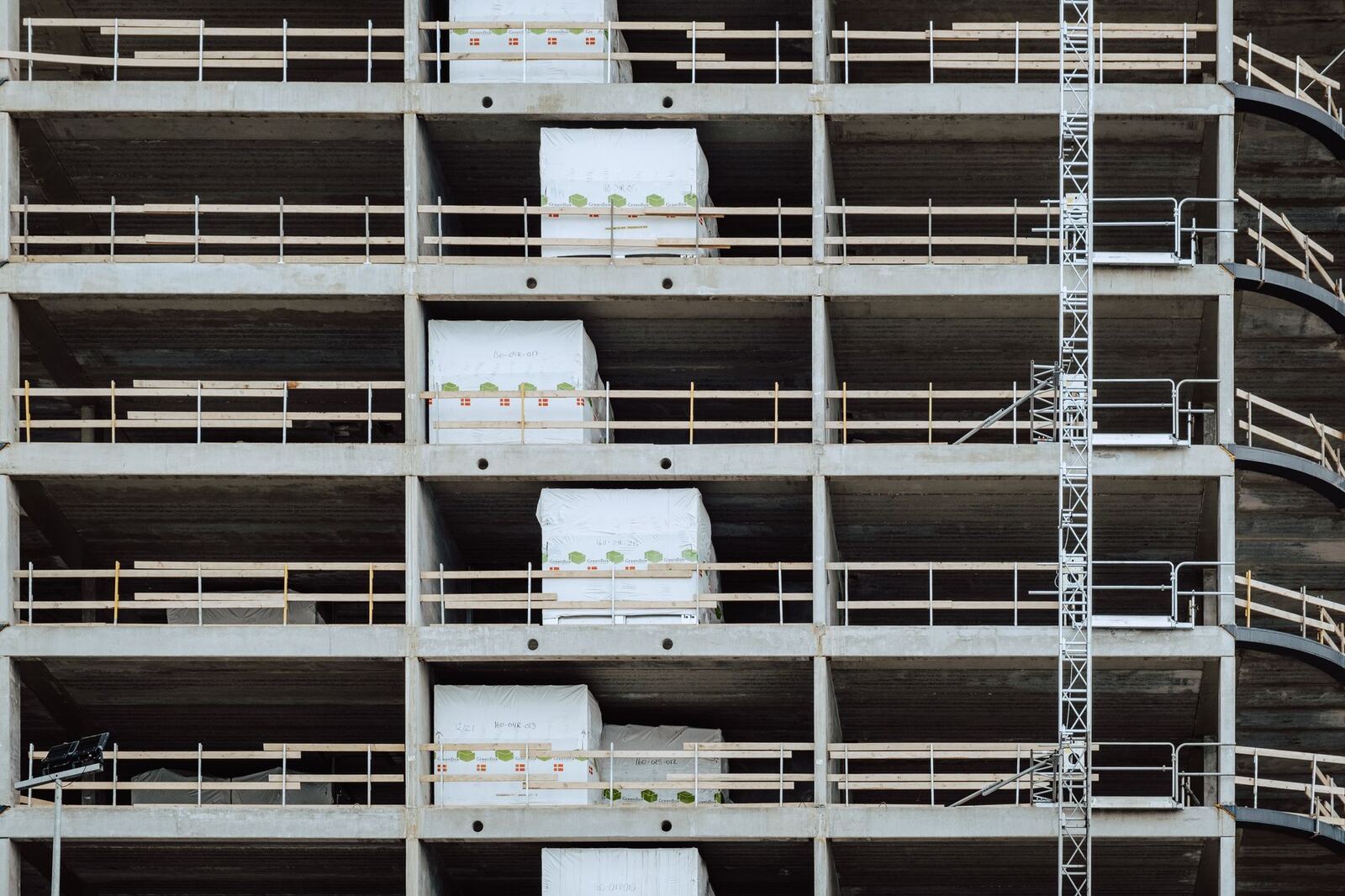 Close-up of a multi-storey building under construction, showcasing steel and concrete structure.